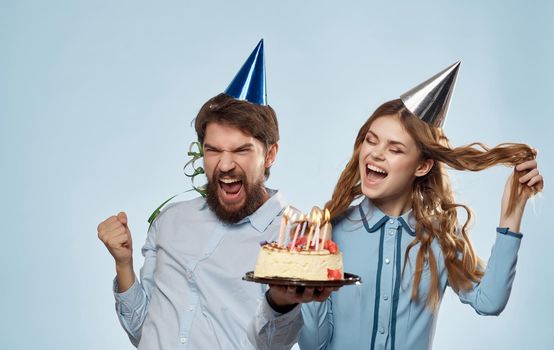 Cheerful young couple birthday celebration fun cake. High quality photo