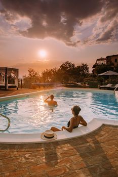 Luxury country house with swimming pool in Italy, Couple on Vacation at luxury villa in Italy, men and woman watching sunset