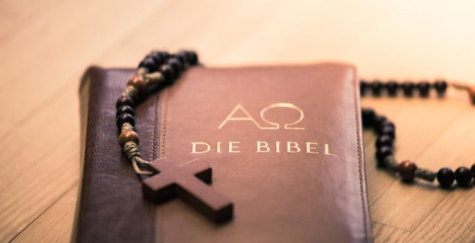 Holy bible and rosary: Christian bible and rosary on a wooden desk