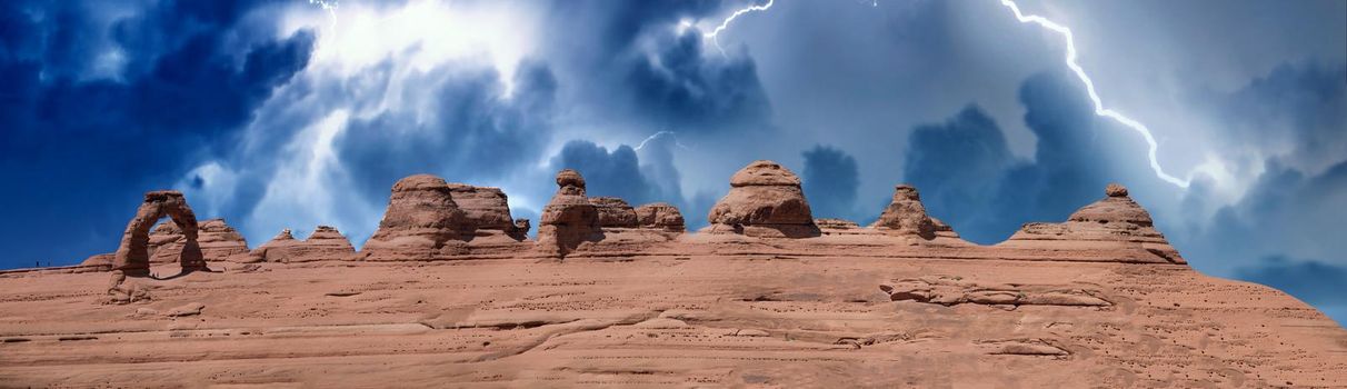 Delicate Arch panoramic view, Arches National Park. High resolution image of rock formations during a storm