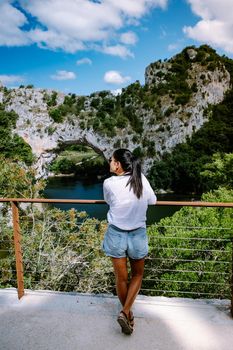 woman on vacation in the Ardeche France Pont d Arc, Ardeche France,view of Narural arch in Vallon Pont D'arc in Ardeche canyon in France