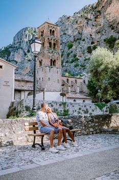 The Village of Moustiers-Sainte-Marie, Provence, France June 2020, couple visit the Provence