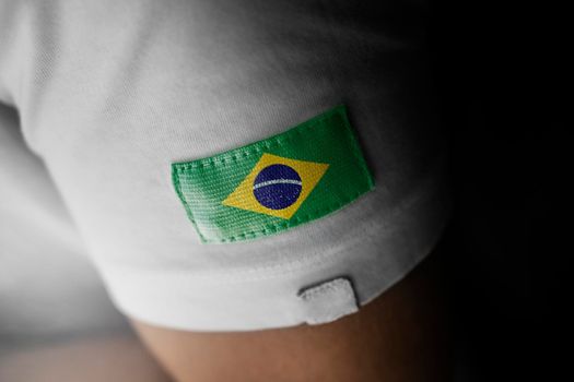 Patch of the national flag of the Brazil on a white t-shirt