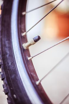 Bike in the city: Close up picture of the tyre outlet and spokes