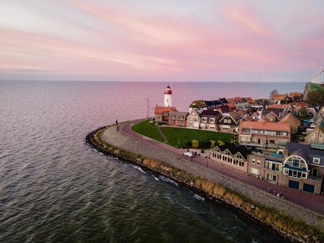 Urk lighthouse with old harbor during sunset, Urk is a small village by the lake Ijsselmeer in the Netherlands Flevoland area