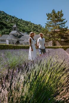 couple visit the old town of Gordes Provence,Blooming purple lavender fields at Senanque monastery, Provence, southern France