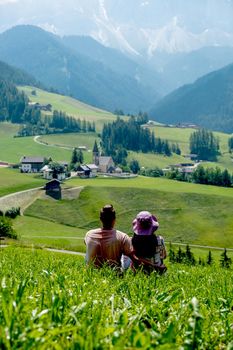 couple on vacation in the Dolomites Italy, Santa Magdalena Village in Dolomites area Italy Val di Funes