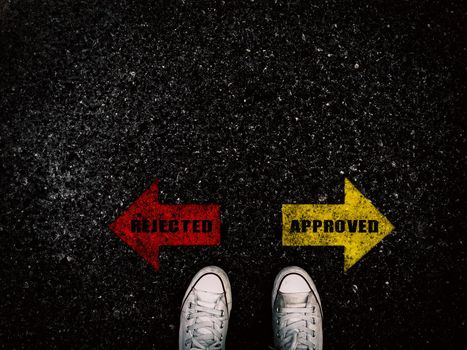 Rejected and approved red and yellow arrow on street and sneaker shoe background, business concept