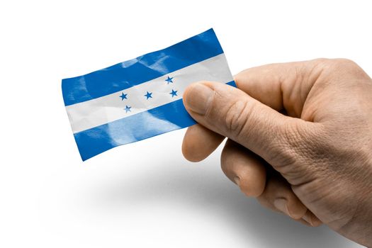 Hand holding a card with a national flag the Honduras