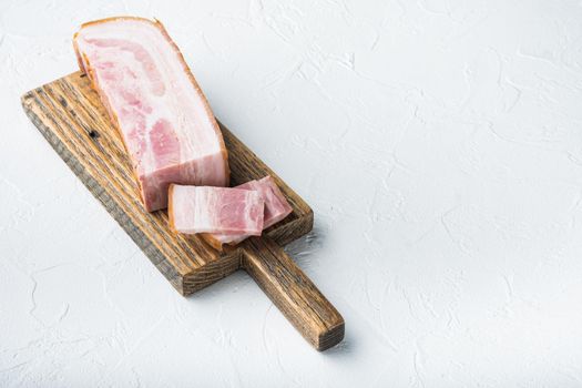 Smoked bacon, whole slab on white background with space for text