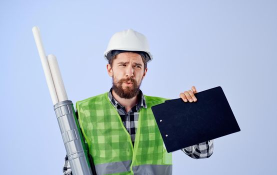 Male builder in green vest white blueprints engineer profession
