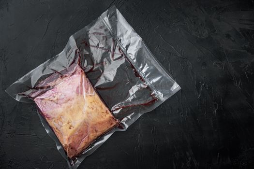 Top sirloin beef cut in plastic pack, on black background, top view, with copy space for text