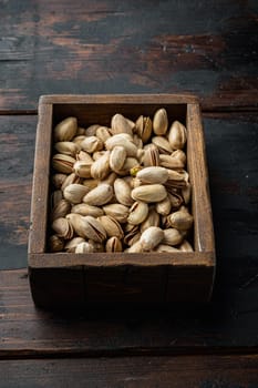 Shelled unsalted pistachios, on old wooden table, top view
