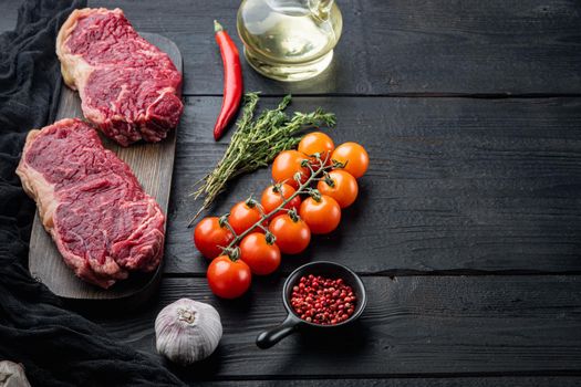 Fresh beef boneless club steak, on black wooden background, with copy space for text