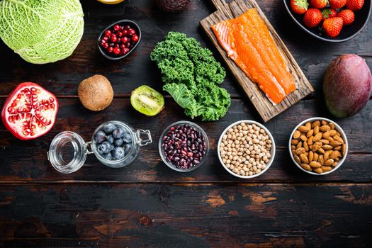 Superfoods dieting concept, top view on dark wooden background, with copy space