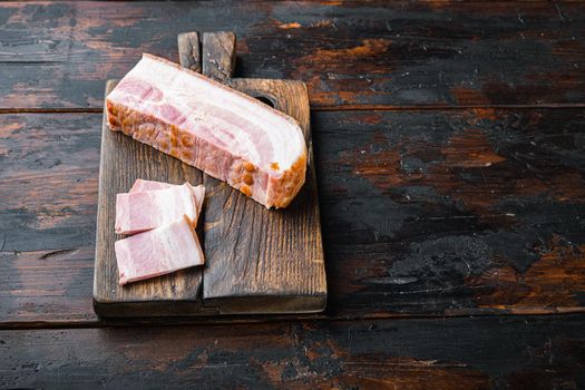 Smoked bacon, whole slab on wooden surface with space for text
