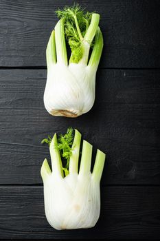 Fresh florence fennel bulbs, on black wooden table, flat lay