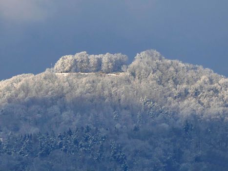 view in winter to the emperor hill Hohenstaufen with snow and sun in Germany