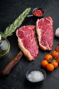 Short loin raw beef steak, on black background