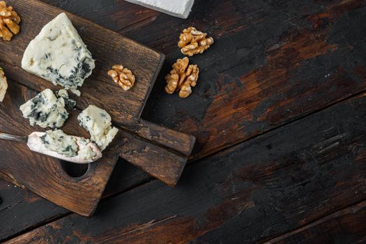 French roquefort cheese, on dark wooden background, flat lay with copy space for text