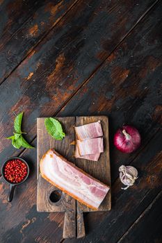 Smoked bacon, whole slab with herbs on wooden surface, top view with space for text