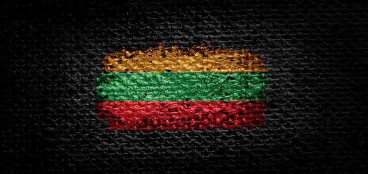 National flag of the Lithuania on dark fabric