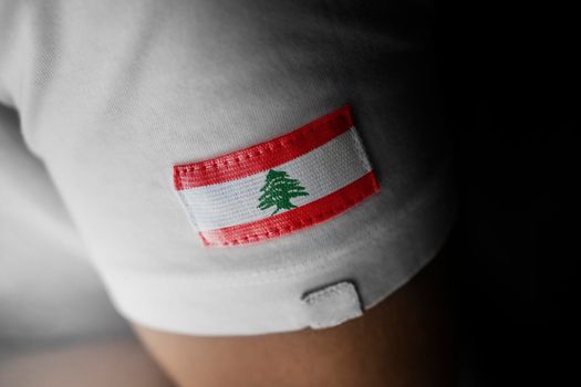 Patch of the national flag of the Lebanon on a white t-shirt
