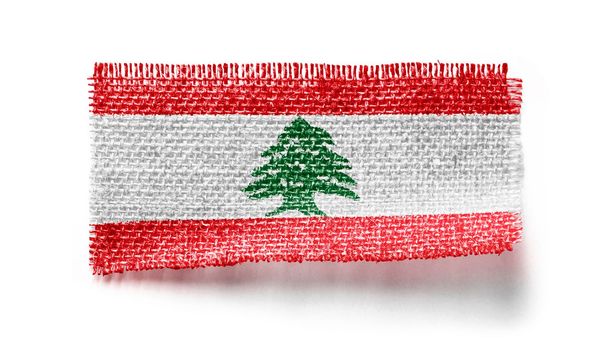 Lebanon flag on a piece of cloth on a white background