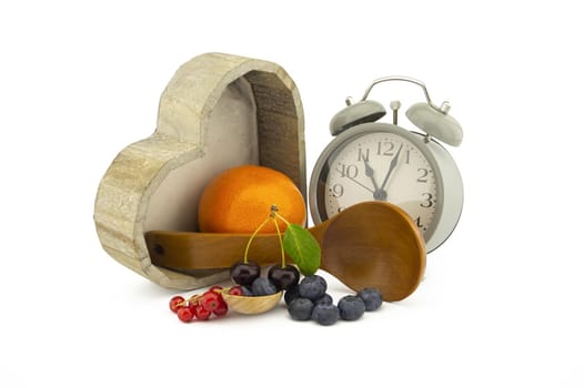 Culinary still life with clock, spoons and berries