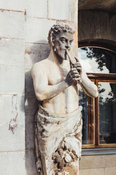 ALUPKA, CRIMEA - February 10, 2015. Statue of Satyr playing the pipe in front of Massandra Palace. Chateauesque villa of Emperor Alexander III of Russia