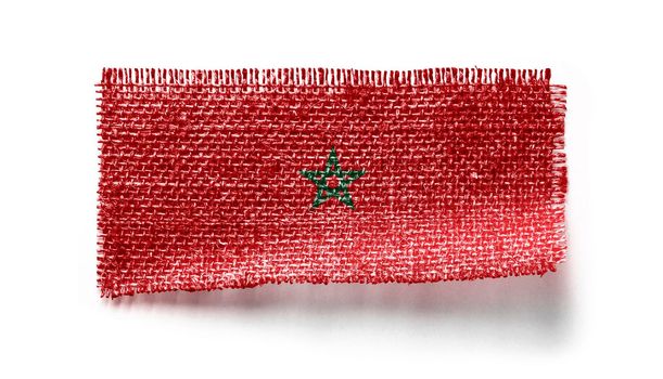 Morocco flag on a piece of cloth on a white background