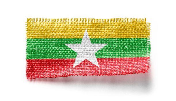 Myanmar flag on a piece of cloth on a white background