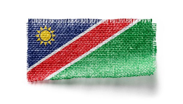 Namibia flag on a piece of cloth on a white background