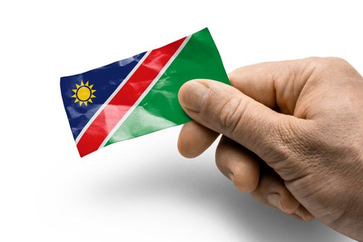 Hand holding a card with a national flag the Namibia