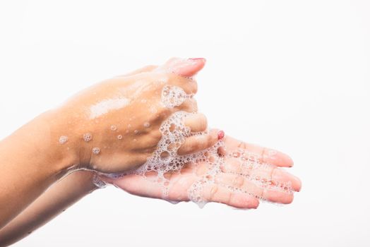 Woman washing hands by soap for cleanliness