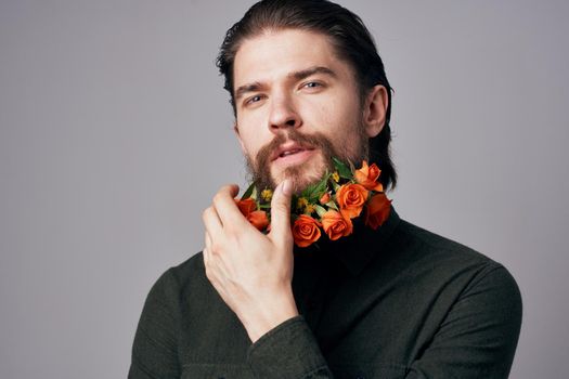 handsome man flowers in a beard black jacket elegant style romance. High quality photo