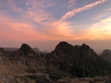 Sunset and pink sky at Roque Nublo the volcanic rock 