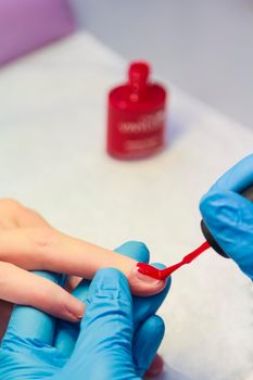 Closeup of Woman applying nail varnish to finger nails