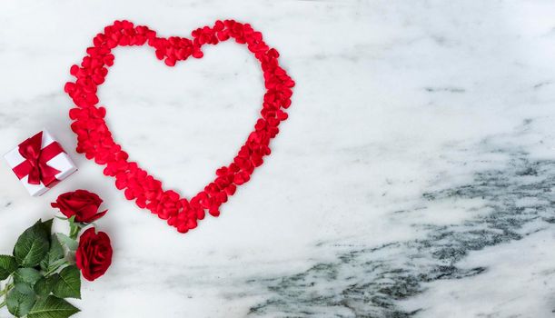 Happy Valentines Day with lovely red outline shape of large heart and romantic gifts on natural marble stone background 