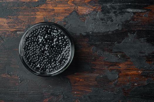 Black Caviar, on old dark wooden table background, top view flat lay with copy space for text