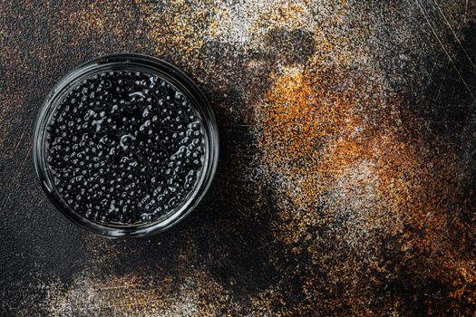 Black Caviar, on old dark rustic background, top view flat lay with copy space for text