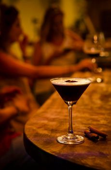 espresso martini cocktail drink in cozy dark bar interior