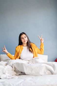 young beautiful brunette woman sitting awake in bed
