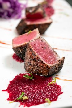 gourmet seared tuna in black pepper crust with beetroot coulis