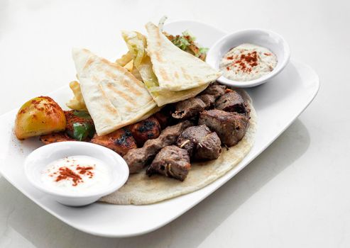 lebanese meshwi mixed grilled meat set on plate