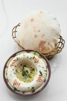 bowl of fresh organic hummus lebanese food  on white table