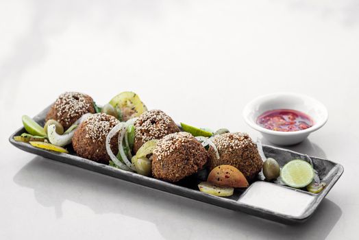 lebanese falafel plate with pickles salad and sauces