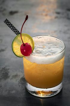 peach screwdriver mixed vodka cocktail drink outdoors at sunset 