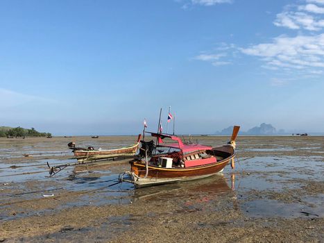 Long-tail boats during low tide