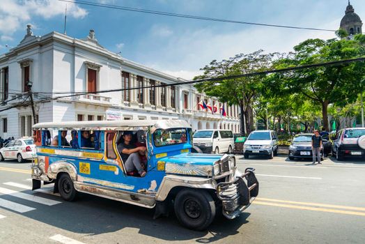 jeepney bus local transport traffic in downtown manila city street philippines